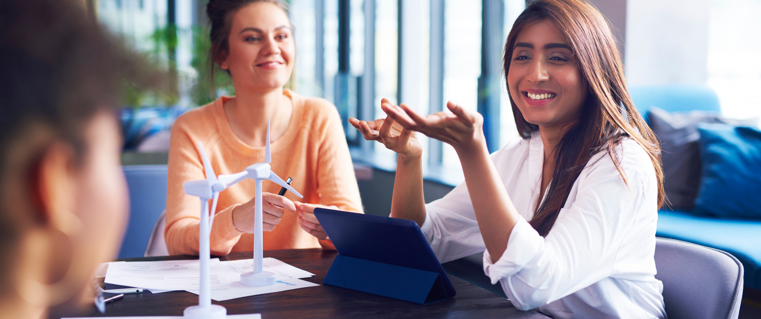 Young adult coworkers having a conversation at office table